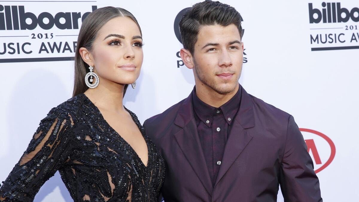 Olivia Culpo and Nick Jonas on the red carpet at the 2015 Billboard Music Awards in May.