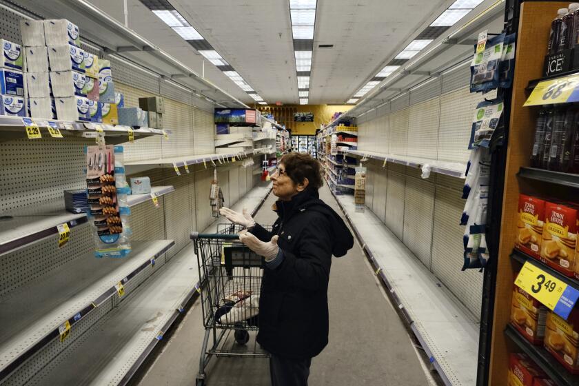A gloved grocery shopper is dismayed over empty shelves at a local Ralphs supermarket in an attempt to stock up on supplies, Friday, March 13, 2020, in the Panorama City section of Los Angeles. Officials said Friday the Los Angeles Unified School District and San Diego school districts will close starting March 16 because of the coronavirus threat. The vast majority of people recover from the new coronavirus. According to the World Health Organization, most people recover in about two to six weeks, depending on the severity of the illness. (AP Photo/Richard Vogel)