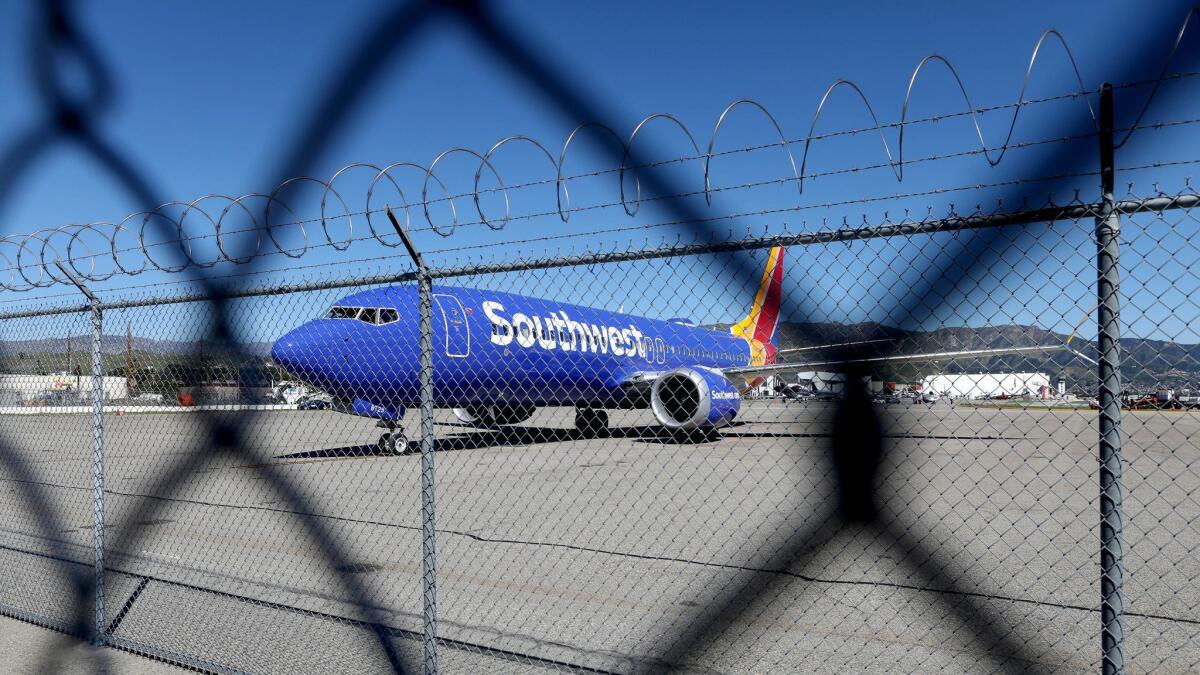A Southwest Airlines Boeing 737 Max 8 sits idle at Burbank Airport.
