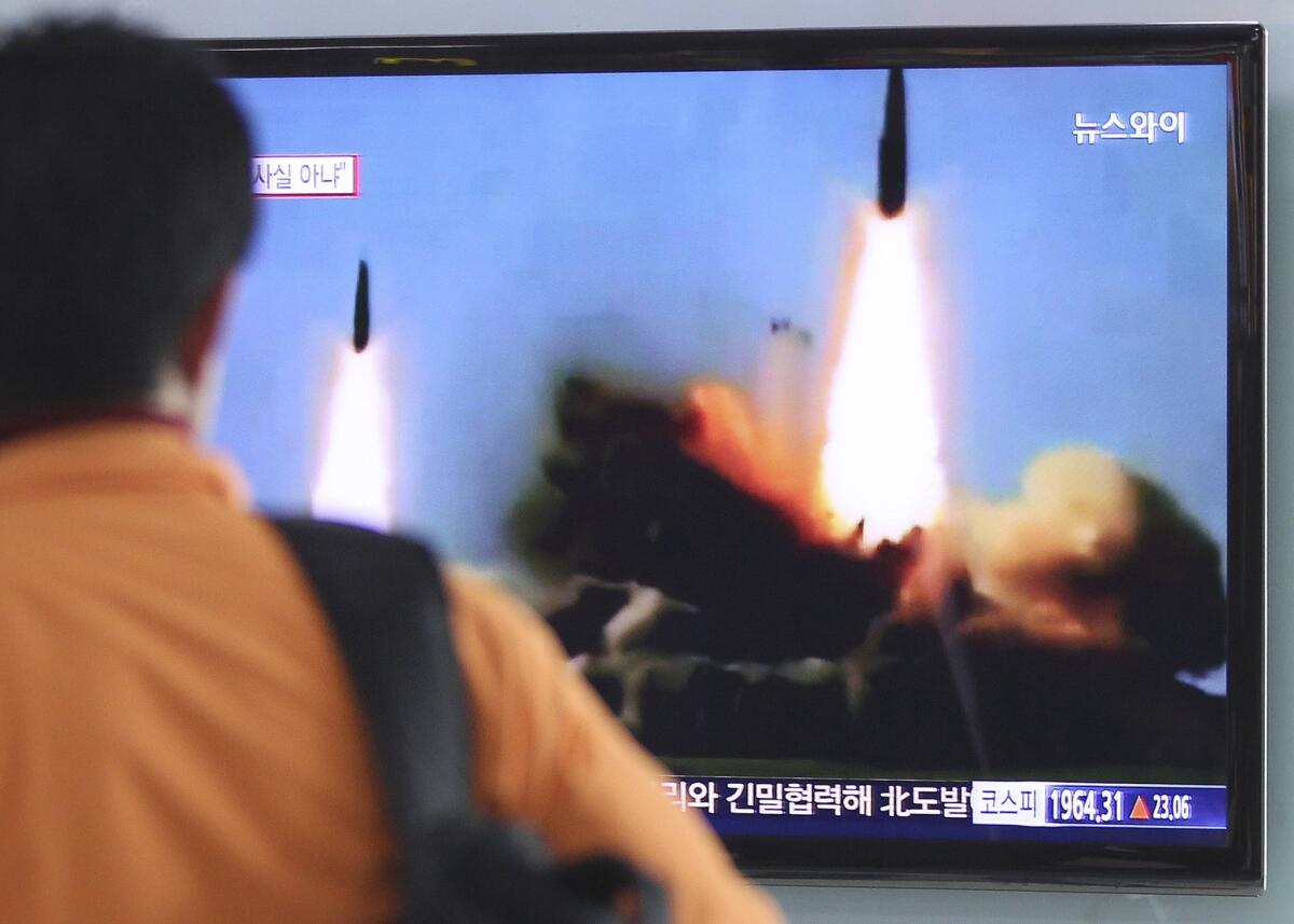 A man in Seoul watches TV news showing North Korea's launch of two medium-range ballistic missiles.