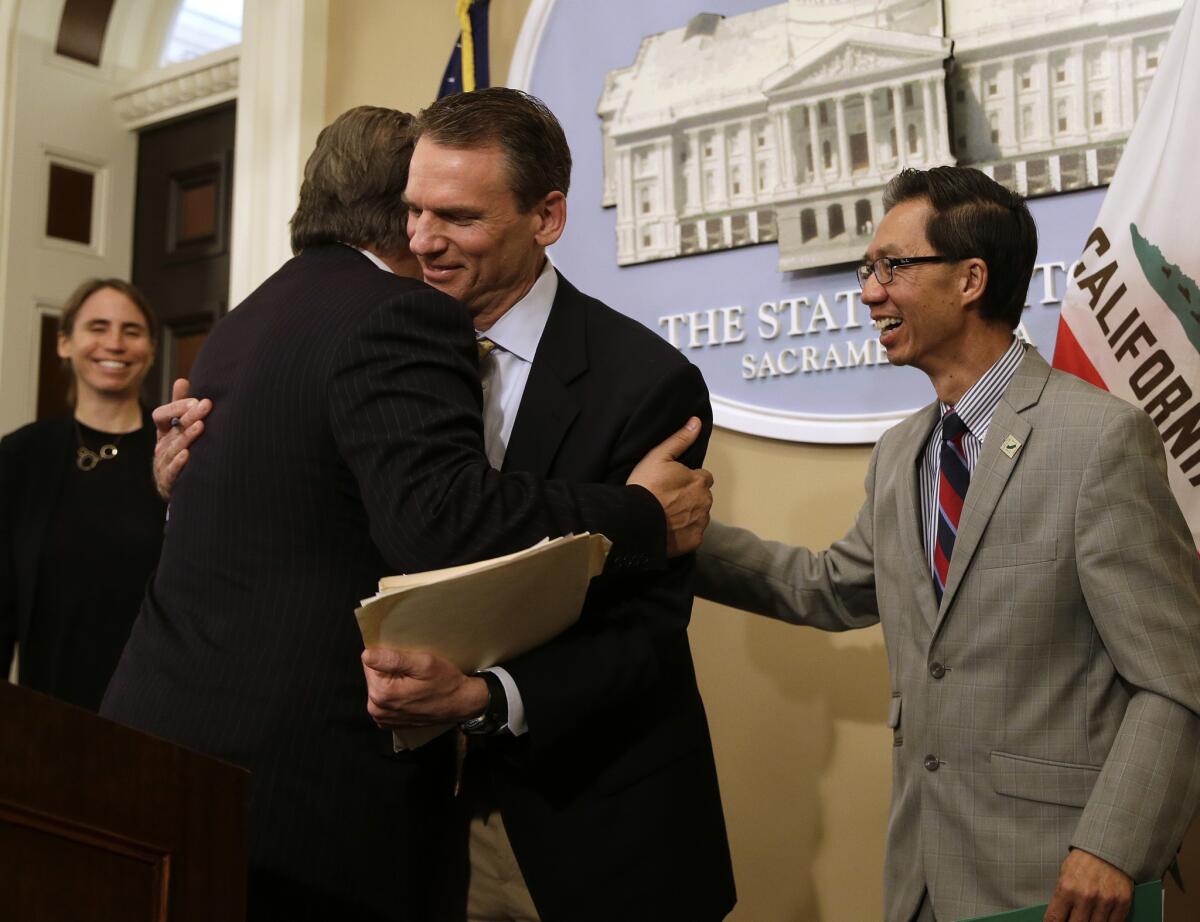 State Sen. Bob Hertzberg (D-Van Nuys), left, and Assemblyman Ed Chau (D-Arcadia), right, celebrate with Alastair Mactaggart, center, whose efforts led to the legislation, after the Legislature approved their data privacy bill in 2018.
