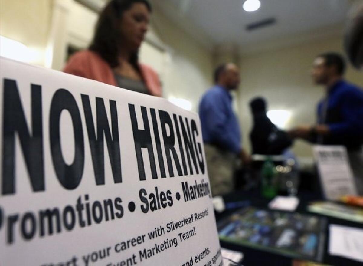 A sign attracts job-seekers during a job fair at the Marriott Hotel in Colonie, N.Y., last month.