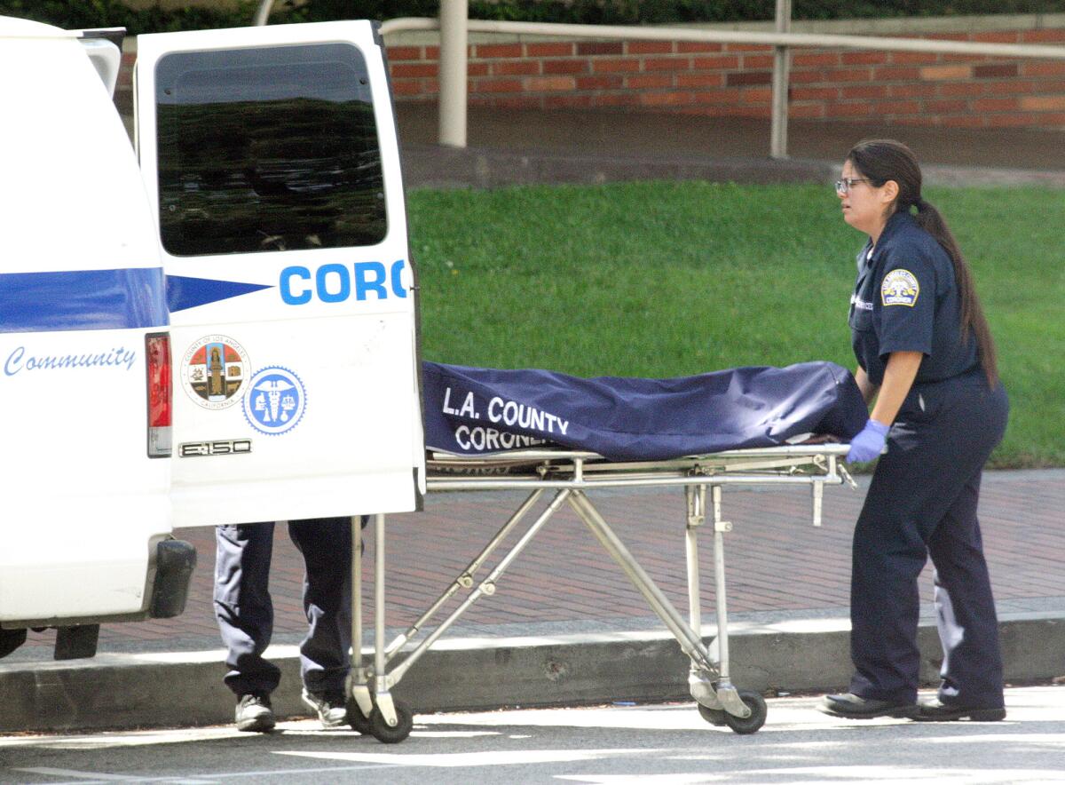 A Los Angeles County coroner loads the body of a stabbing victim into the back of a van in front of the Glendale Courthouse on Monday, September 28, 2015. The victim was identified Tuesday as 57-year-old Alex Littlejohn, Los Angeles County coroner’s officials said.