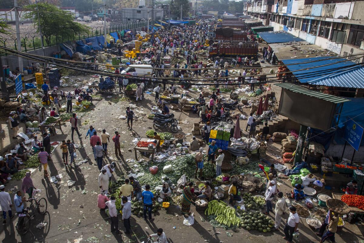 Indian shopkeepers and customers jammed a marketplace in New Delhi a day after a nationwide lockdown.