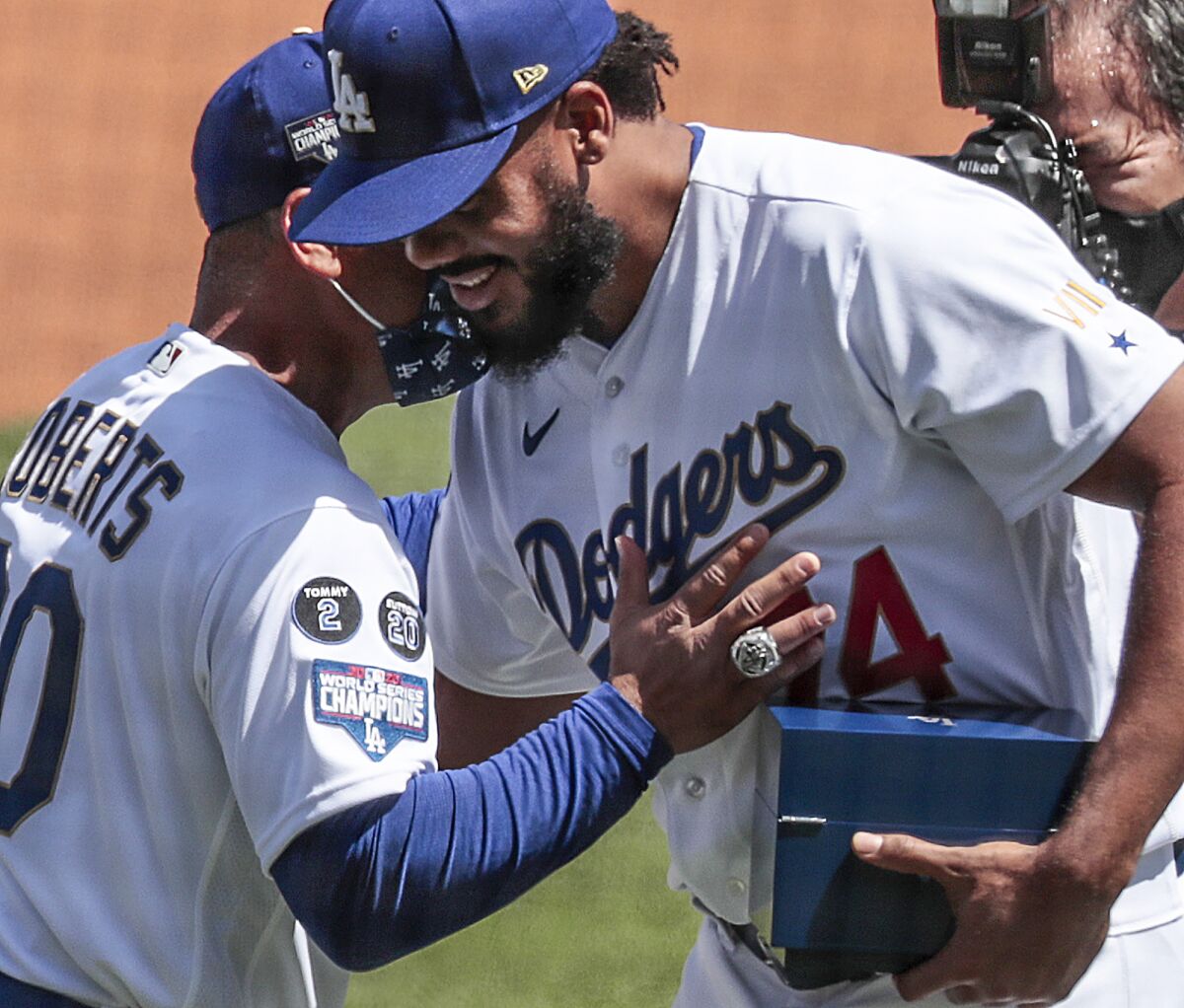 Dodgers pitcher Kenley Jansen is congratulated by Dodgers manager Dave Roberts.