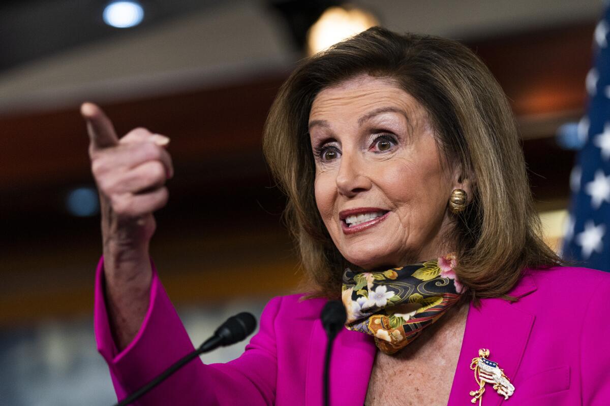 House Speaker Nancy Pelosi points from the podium