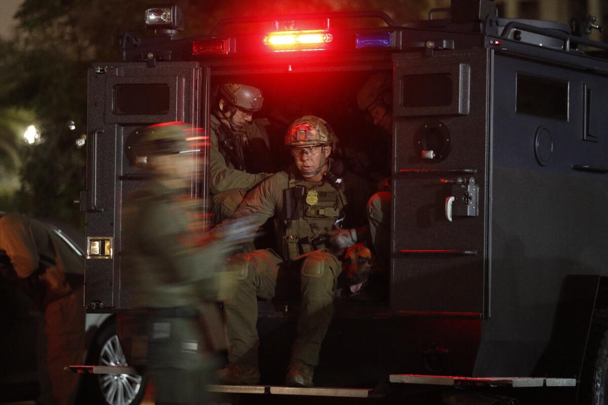 ATF agents board a truck to conduct a raid early Wednesday morning in Los Angeles. (Jae C. Hong / Associated Press)