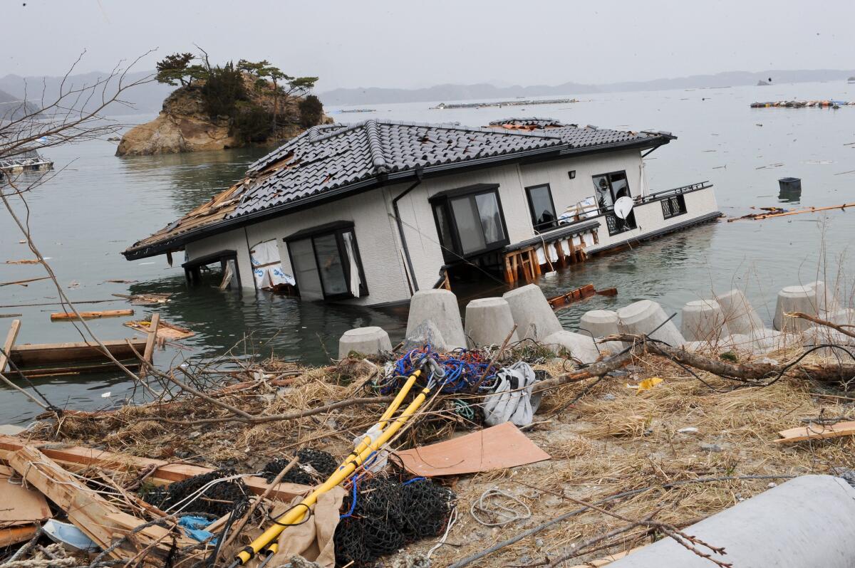 A house lies in the sea off a village near the Onagawa nuclear power plant on March 20, 2011.