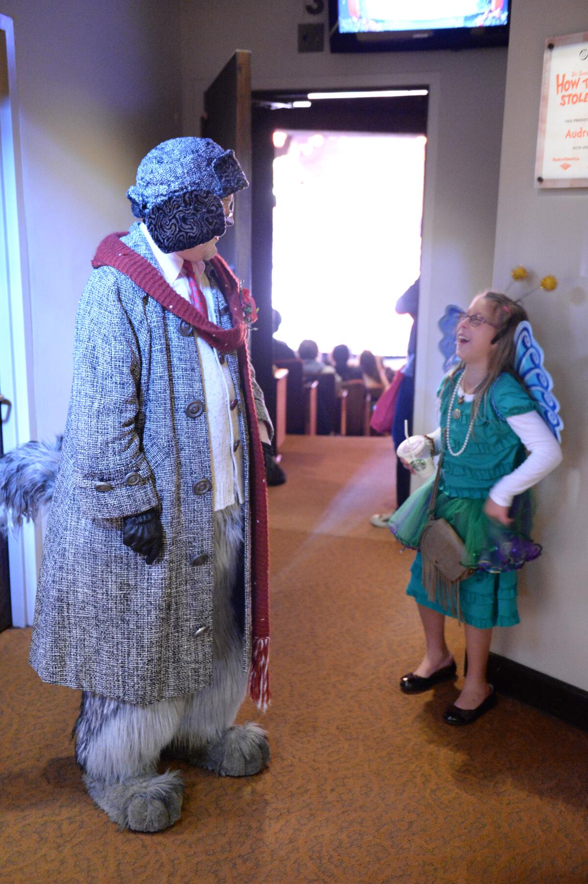 Actor Steve Gunderson and child at sensory-friendly performance of "Dr. Seuss's How the Grinch Stole Christmas!" 