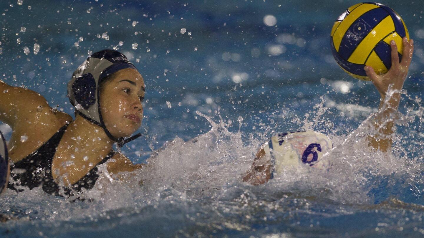 Corona del Mar High's Jaleh Moaddeli (6) scores against Newport Harbor's Kaela Whelan during the second half in the Battle of the Bay girls' water polo match in Newport Beach on Friday.