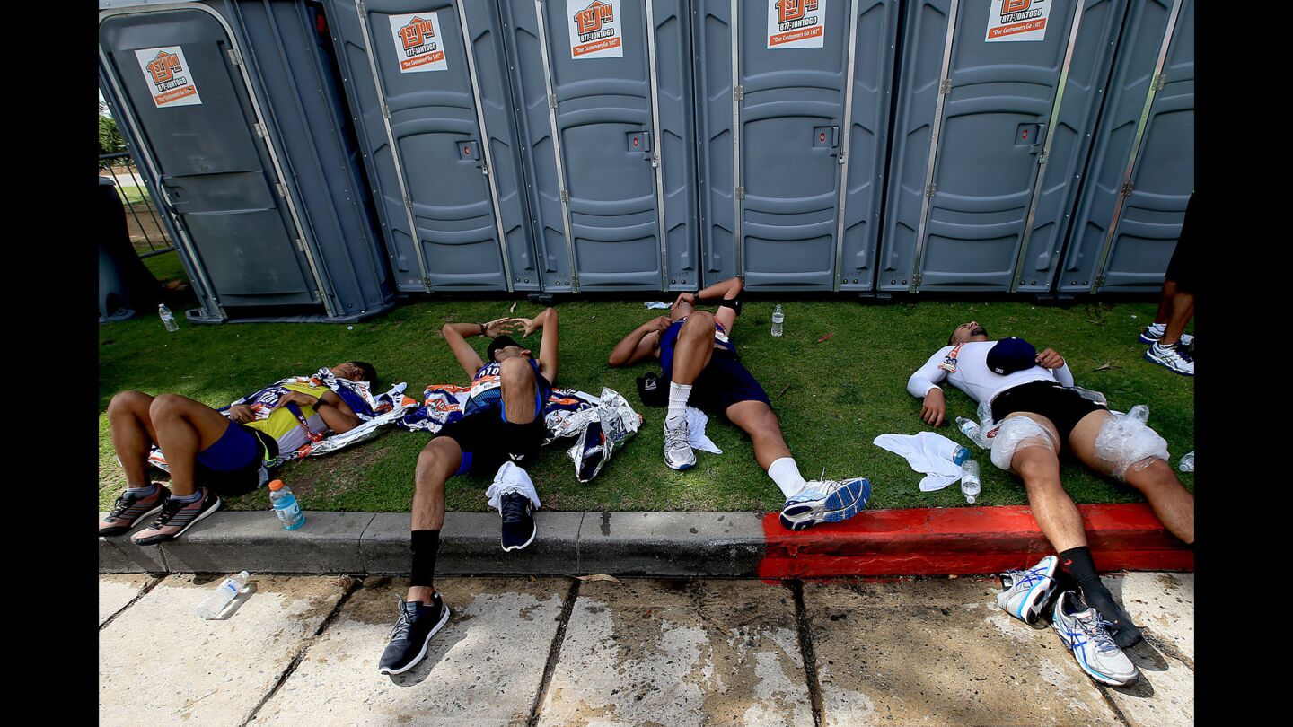 Runners try to recover at the finish line.