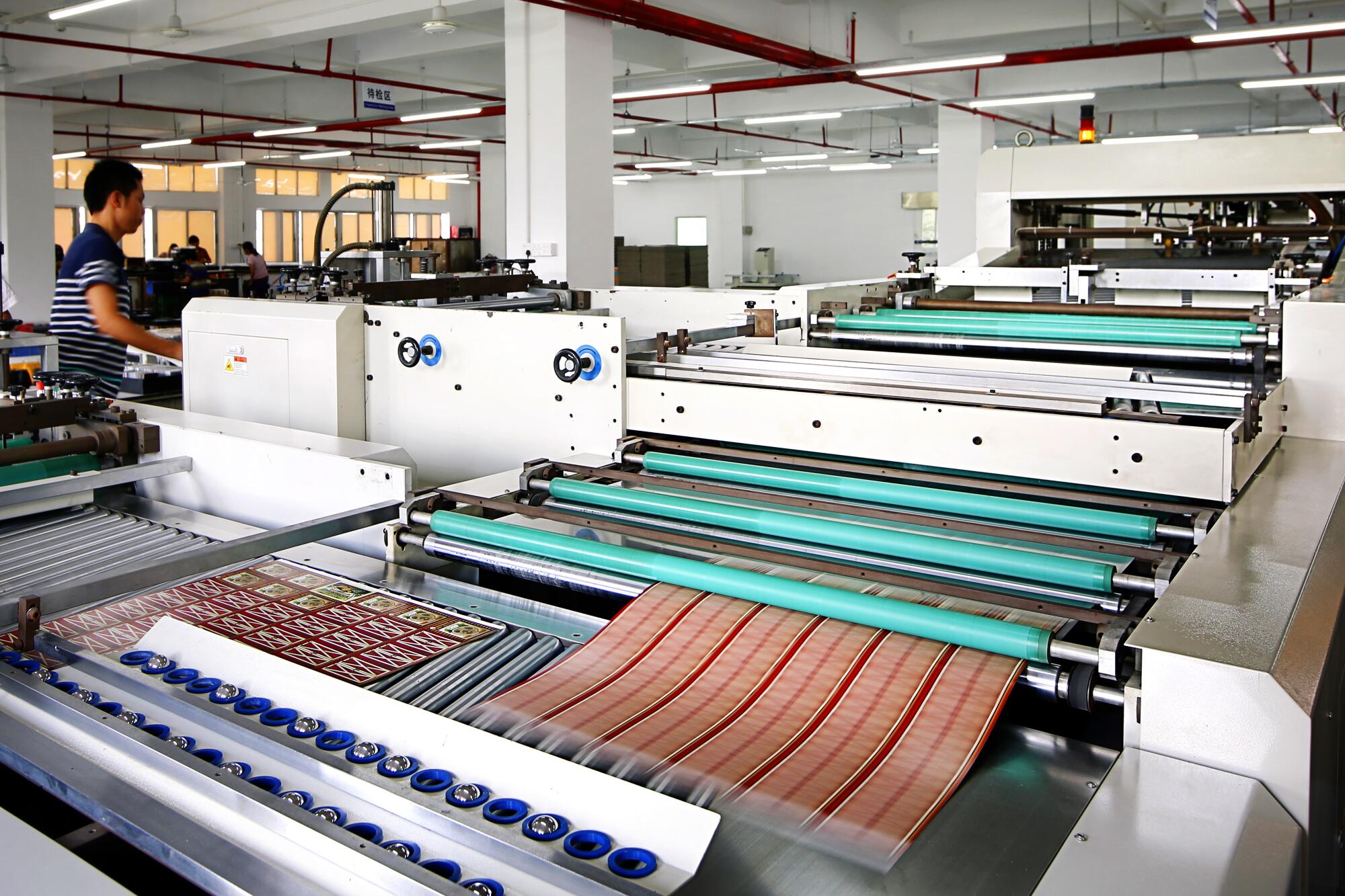 A worker at the Panda Game Manufacturing factory in Shenzhen oversees the production of game components.