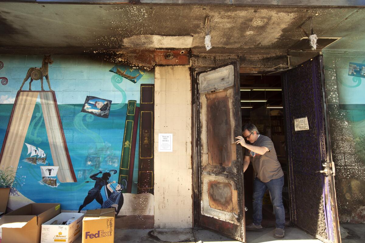 The entry doors of the Iliad show fire damage.