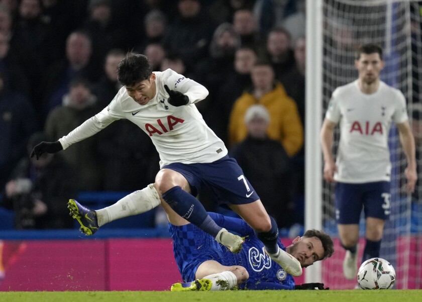 Tottenham's Son Heung-min, top, duels for the ball with Chelsea's Saul during the English League Cup semifinal first leg soccer match between Chelsea and Tottenham Hotspur at Stamford Bridge stadium in London, Wednesday, Jan. 5, 2022. (AP Photo/Kirsty Wigglesworth)