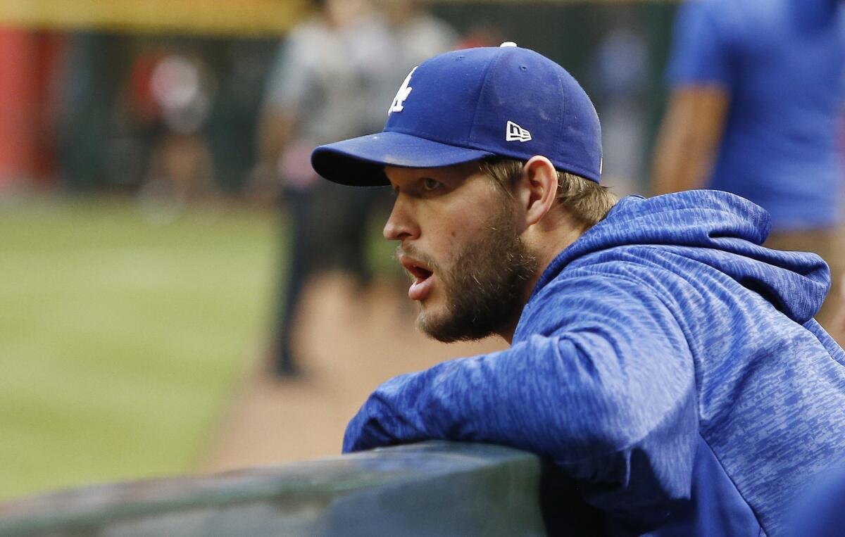 Los Angeles Dodgers starting pitcher Clayton Kershaw hangs out in the dugout prior to a baseball game against the Arizona Diamondbacks Monday, April 30, 2018, in Phoenix. The Diamondbacks defeated the Dodgers 8-5.