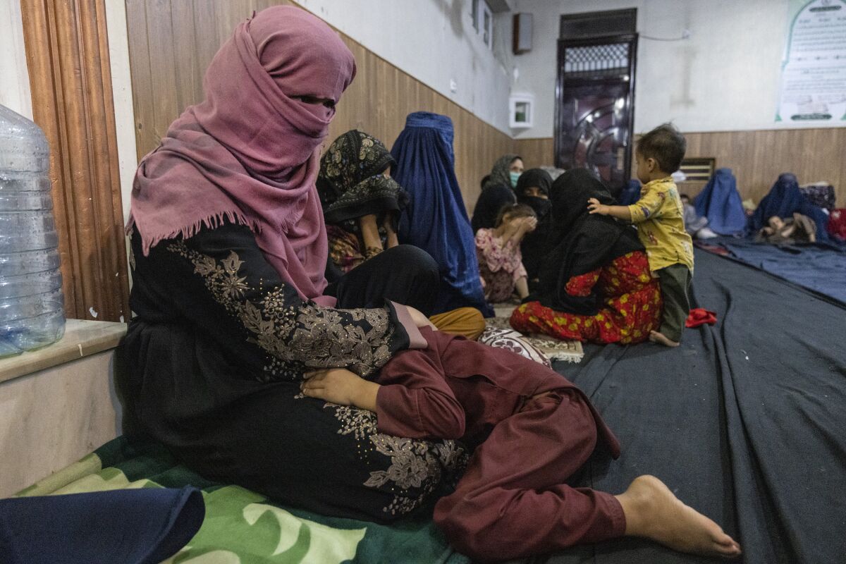 Displaced Afghan women and children from Kunduz are seen at a mosque on August 13, 2021 in Kabul, Afghanistan. 