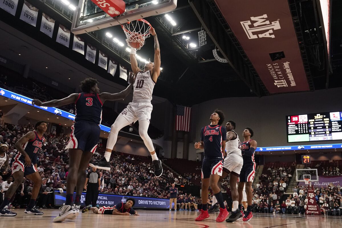 Texas A&M forward Ethan Henderson (10) dunks over Mississippi center Nysier Brooks (3) during the second half of an NCAA college basketball game Tuesday, Jan. 11, 2022, in College Station, Texas. (AP Photo/Sam Craft)