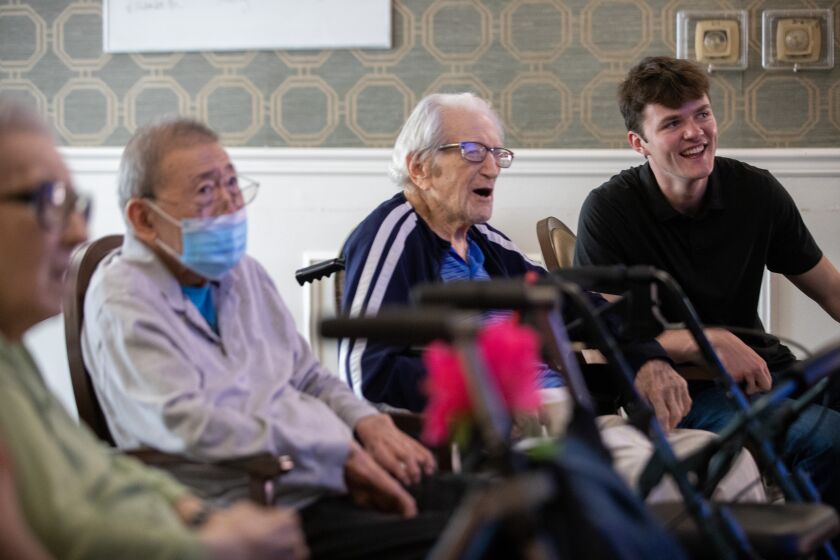 Westwood, CA - May 13: Eddie Nash, a UCLA sophomore and volunteer with the UCLA Brain Exercise Initiative, right, participates in trivia quiz with seniors at a residential facility Saturday, May 13, 2023 in Westwood, CA. (Brian van der Brug / Los Angeles Times)
