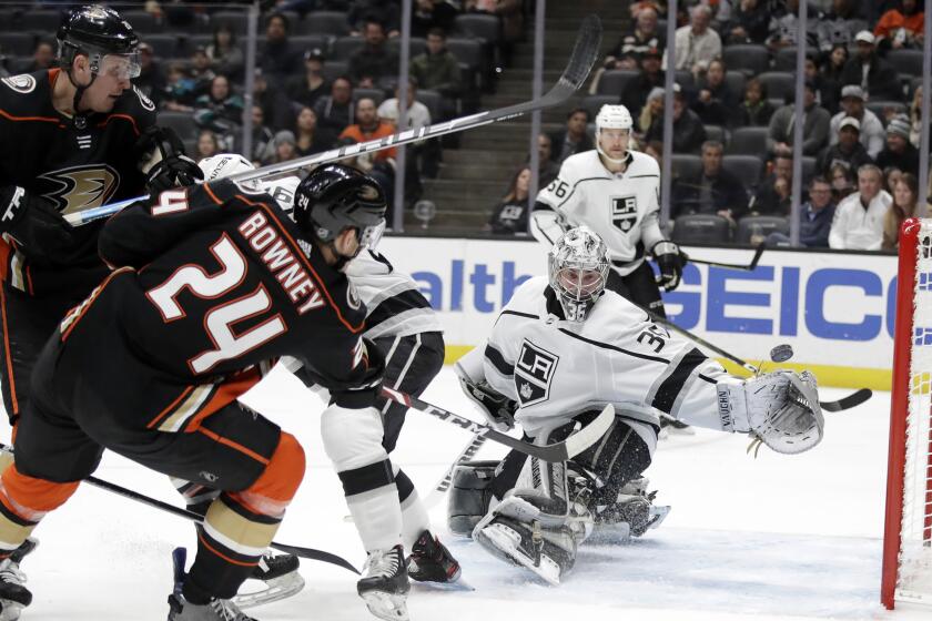 Anaheim Ducks' Carter Rowney (24) scores past Los Angeles Kings goaltender Jack Campbell, center, during the second period of an NHL hockey game, Monday, Dec. 2, 2019, in Anaheim, Calif. (AP Photo/Marcio Jose Sanchez)