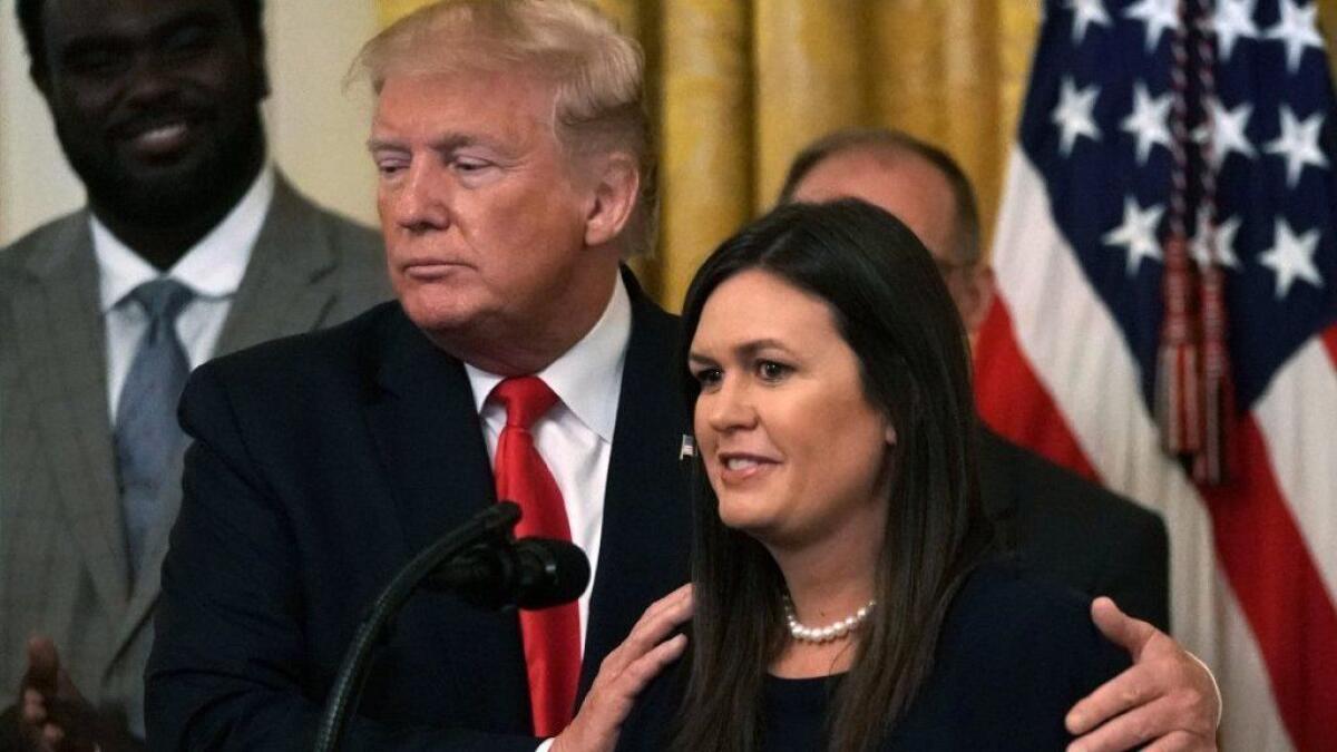 President Trump and White House Press Secretary Sarah Sanders share a moment during an event Thursday at the White House after Trump announced Sanders' impending departure.
