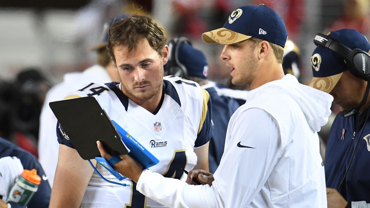 Rams quarterbacks Sean Mannion, left, and Jared Goff talk on the sideline after starter Case Keenum had a pass intercepted in the season opener.