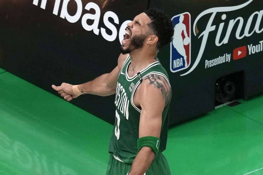 Boston Celtics' Jayson Tatum celebrates after scoring during the first half of Game 5.