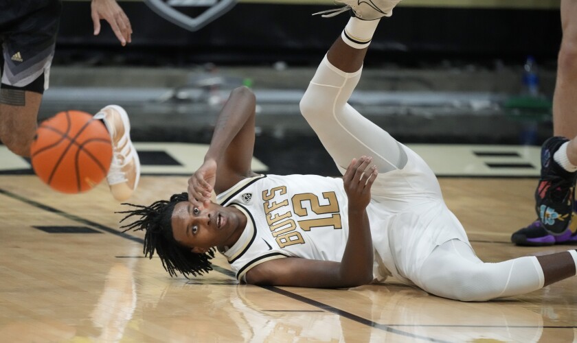 Colorado forward Jabari Walker hits the floor while trying to corral the ball in the first first half of an NCAA college basketball game against Washington, Sunday, Jan. 9, 2022, in Boulder, Colo. (AP Photo/David Zalubowski)