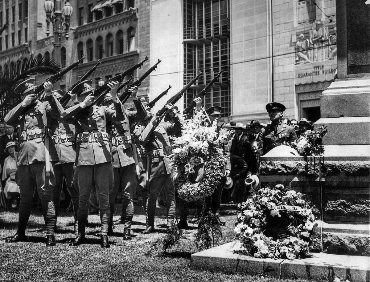 May 30, 1935: A rifle squad from the 160th Infantry fires off a salute during the Memorial Day program at the Pershing Square Soldier's Monument.