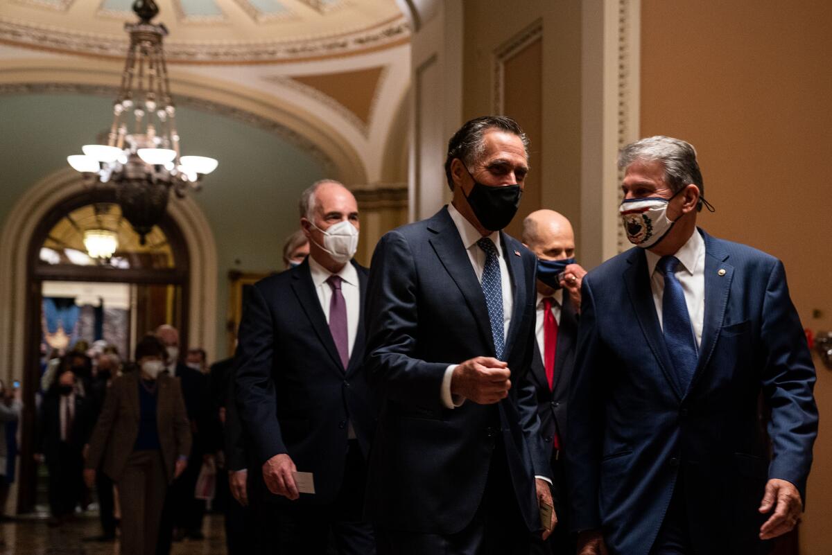 Sen. Mitt Romney (R-Utah), left, and Sen. Joe Manchin (D-W.Va.)