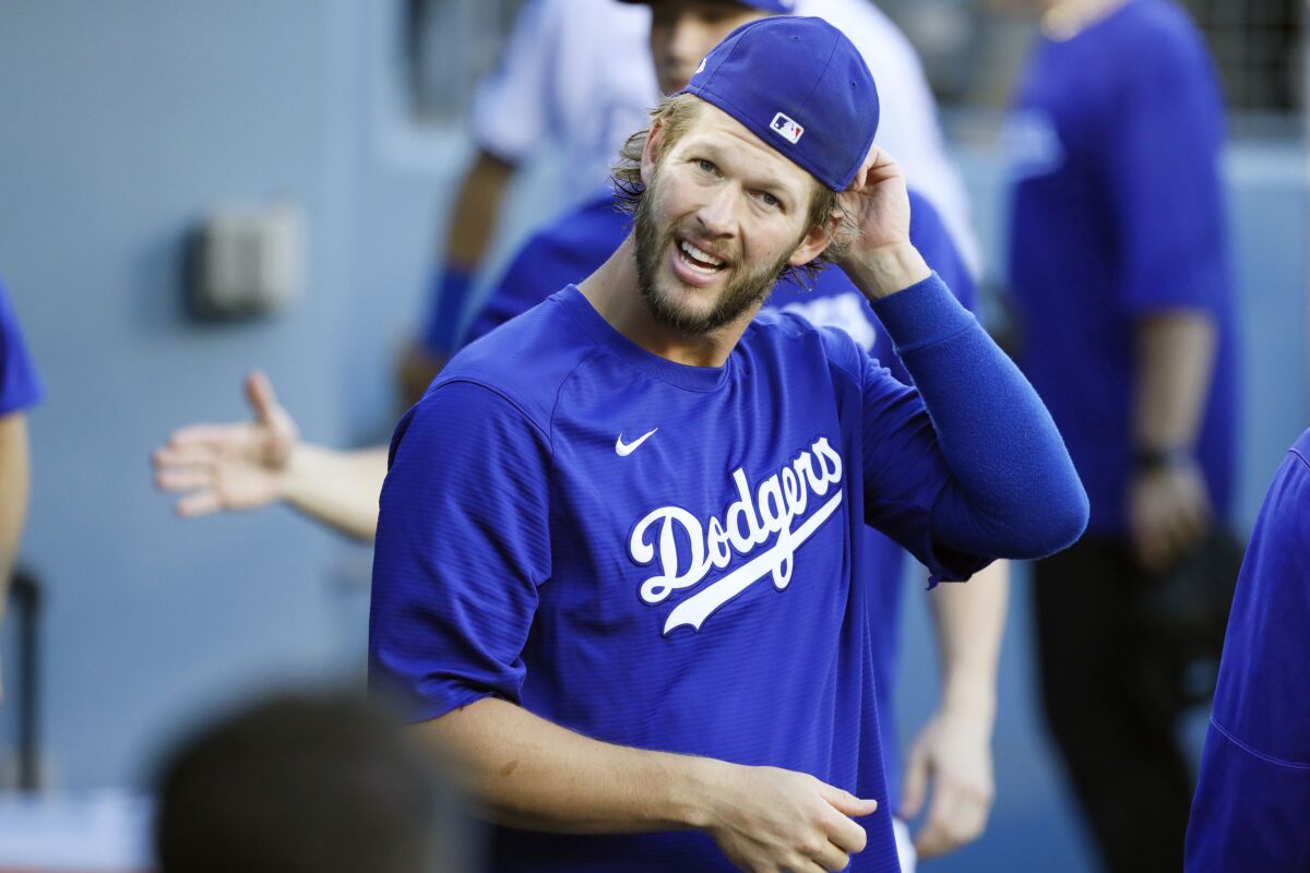 Injured Dodgers pitcher Clayton Kershaw looks on from the dugout before a game against Houston on Aug. 4, 2021.