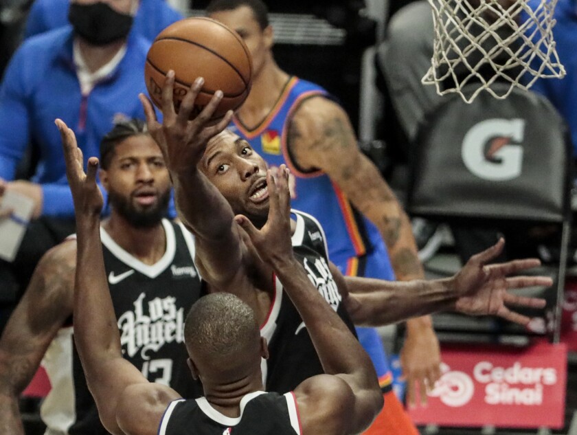 Clippers forward Kawhi Leonard pulls down a rebound during a 108-100 win over the Thunder.