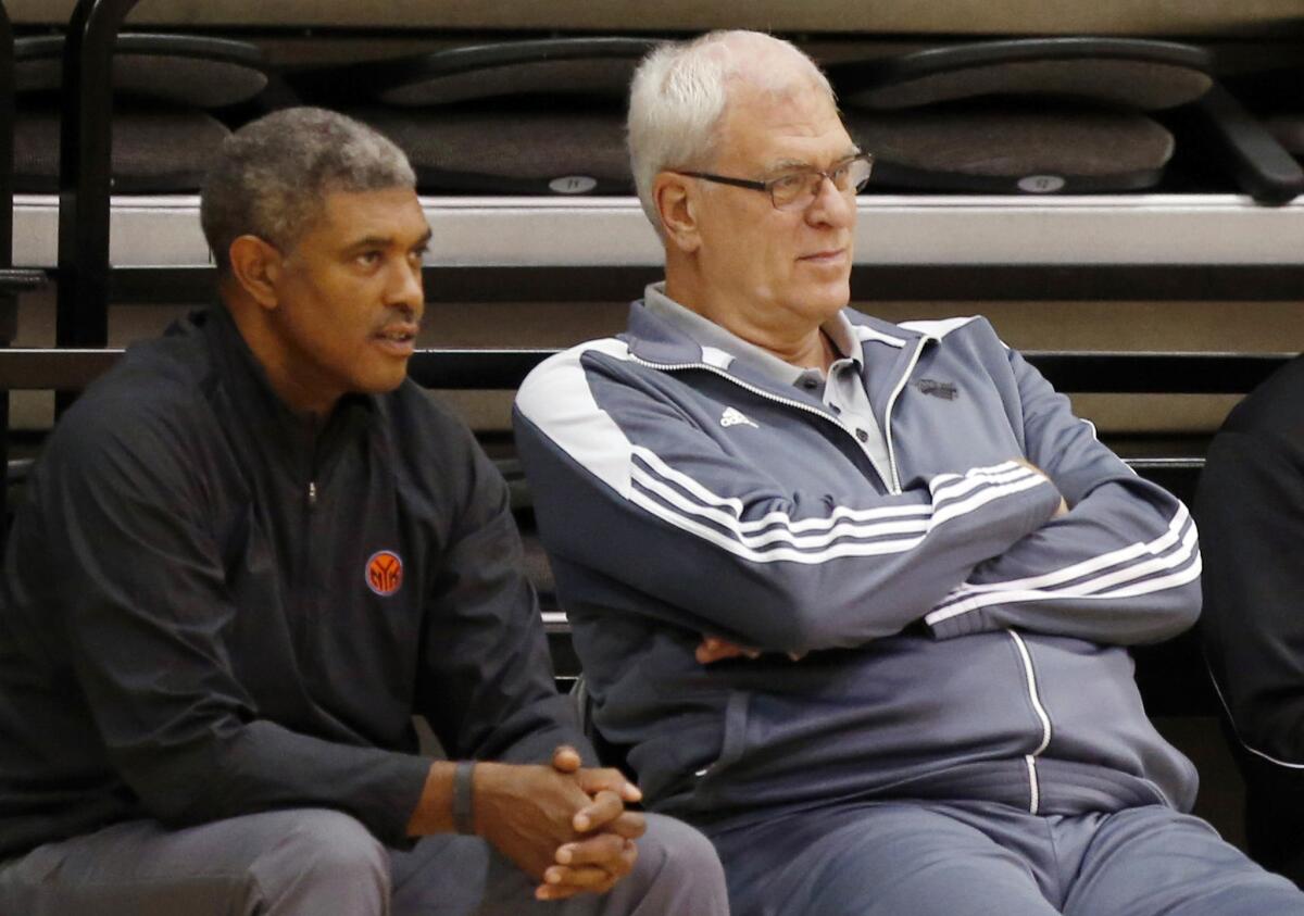 Knicks General Manager Steve Mills (left) and President Phil Jackson look oin during a training camp in Sept. 2014.