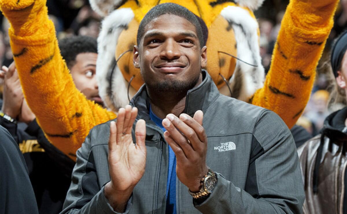 Former Missouri defensive end Michael Sam applauds at a trophy presentation during a basketball game between Missouri and Tennessee. Former NFL player David Kopay met with Sam the day before the All-American announced he was gay.