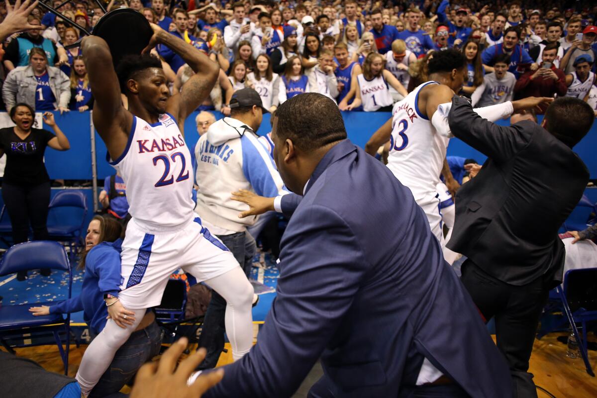 Kansas forward Silvio De Sousa grabs a stool during a brawl which broke out at the end of a Jayhawks game against Kansas State.