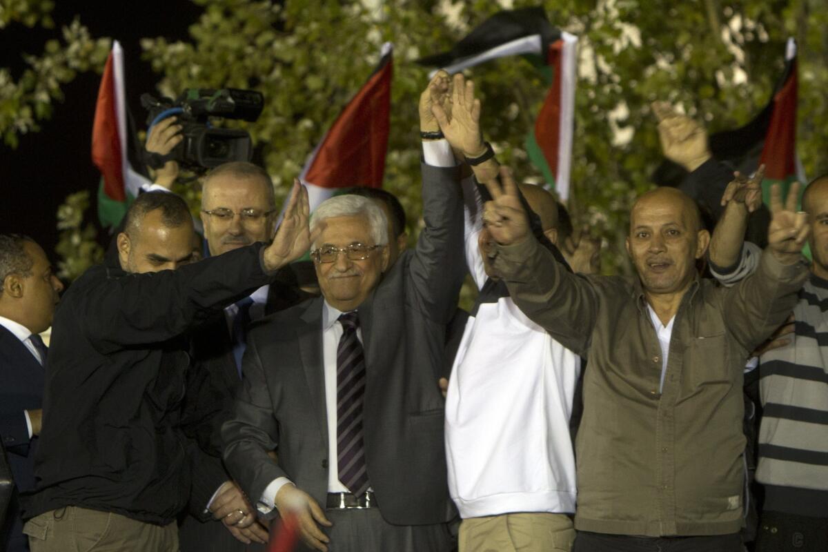 Palestinian Authority President Mahmoud Abbas, wearing tie, greets freed Palestinian prisoners at his headquarters in the West Bank city of Ramallah early Wednesday.