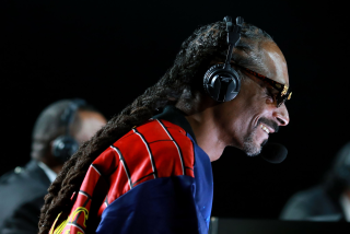 Snoop Dogg provides some boxing commentary during the Mike Tyson vs Roy Jones Jr. event.
