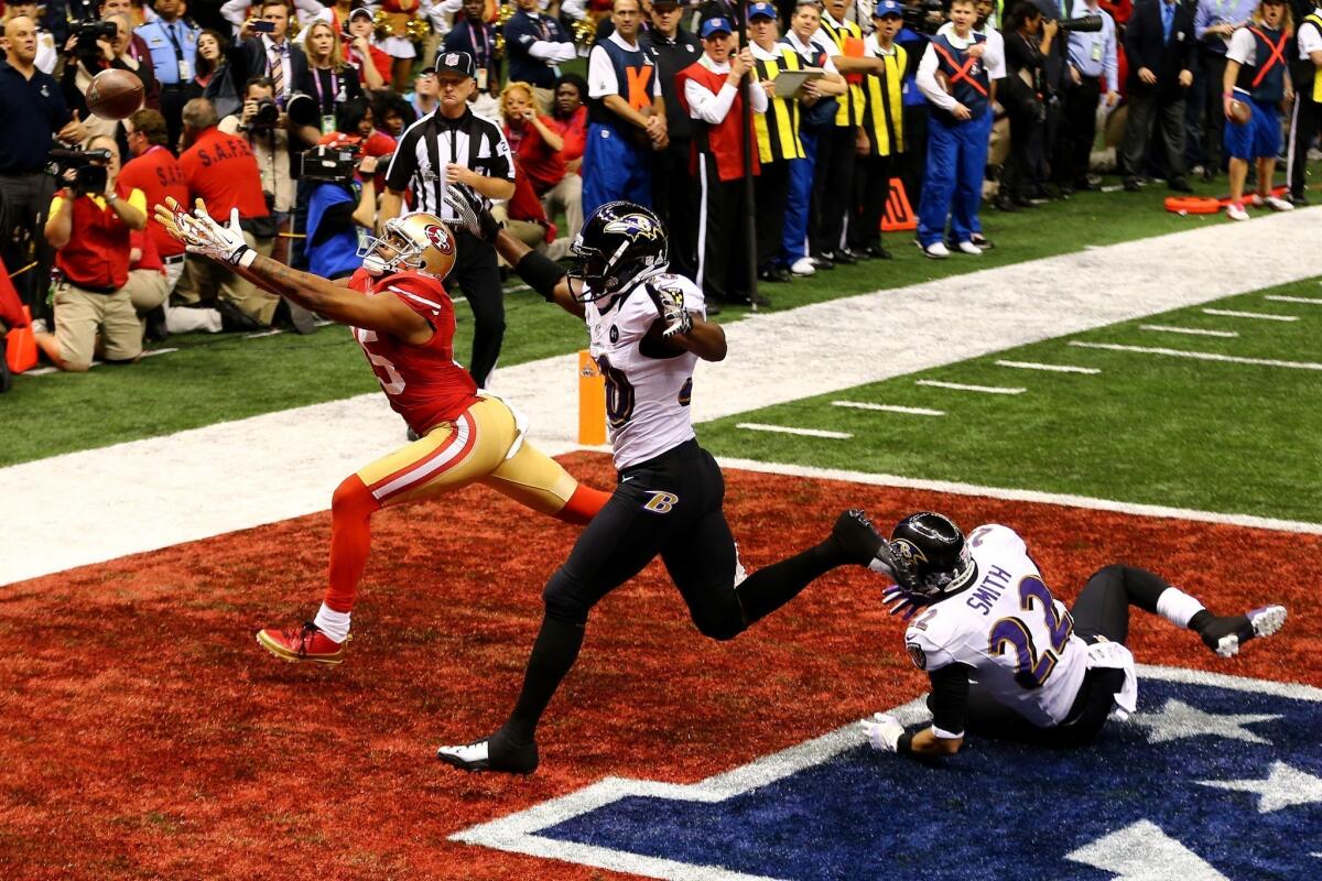 San Francisco's Michael Crabtree, defended by Baltimore's Ed Reed and Jimmy Smith, can't get to a fourth-down pass in the end zone during the final minutes of Super Bowl XLVII.