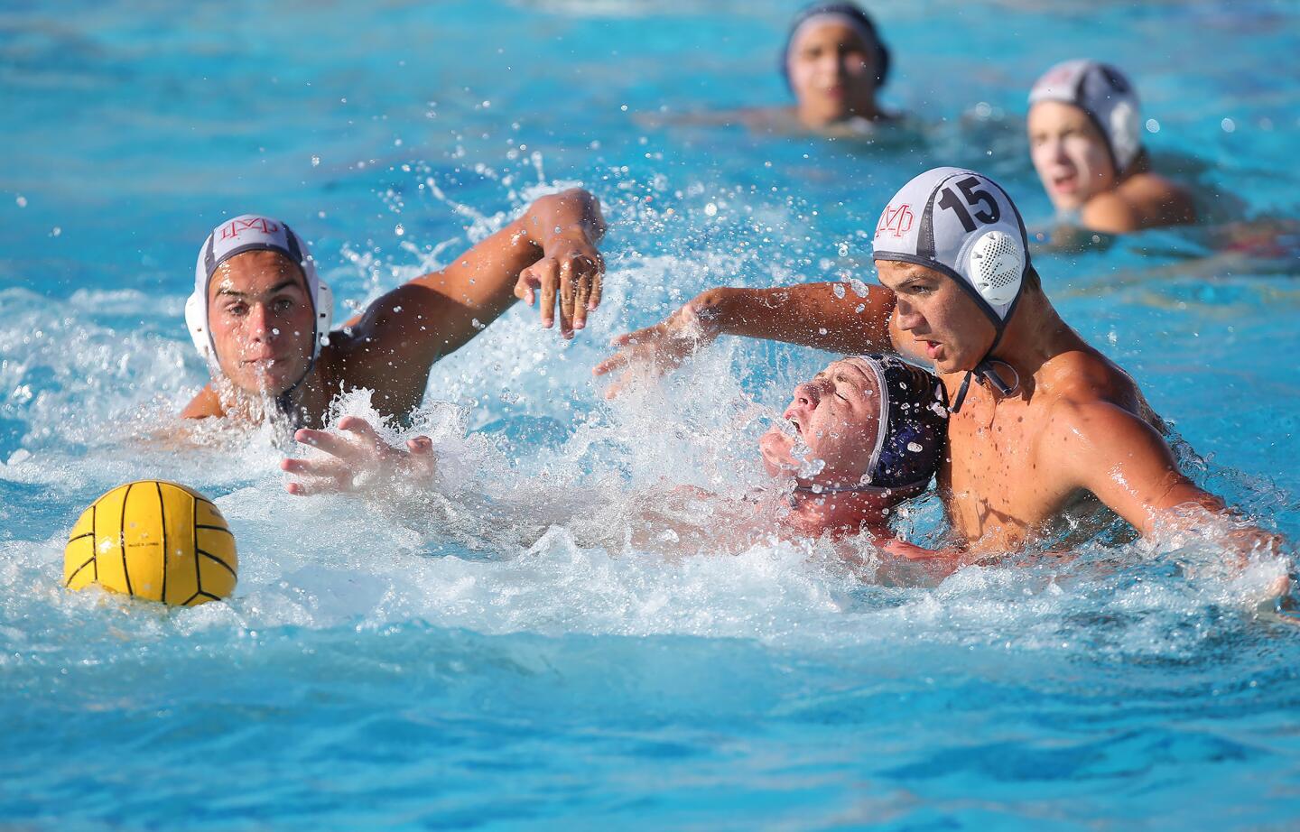 Newport Harbor High's Ike Love battles Mater Dei's Max Rossi (14) as he tries to gain control for a shot during a nonleague boys' water polo game at Newport Harbor on Thursday.