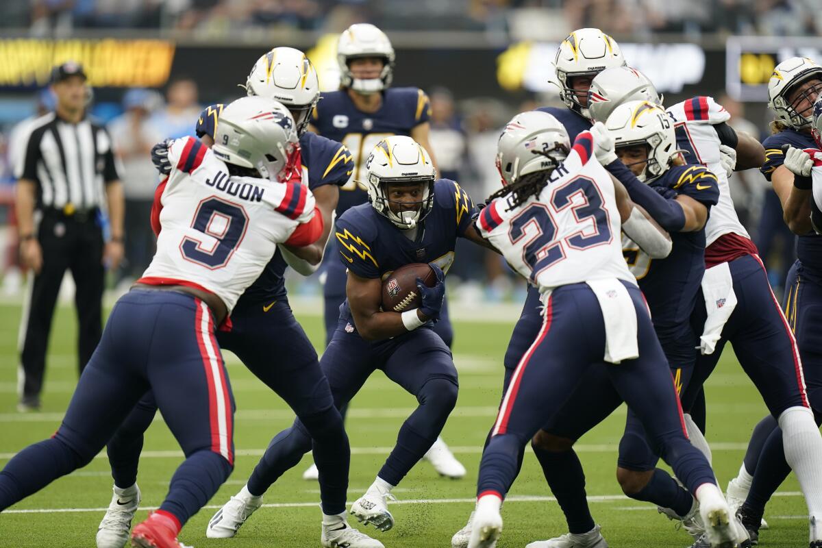 The Chargers'  Justin Jackson looks for running room against the Patriots.