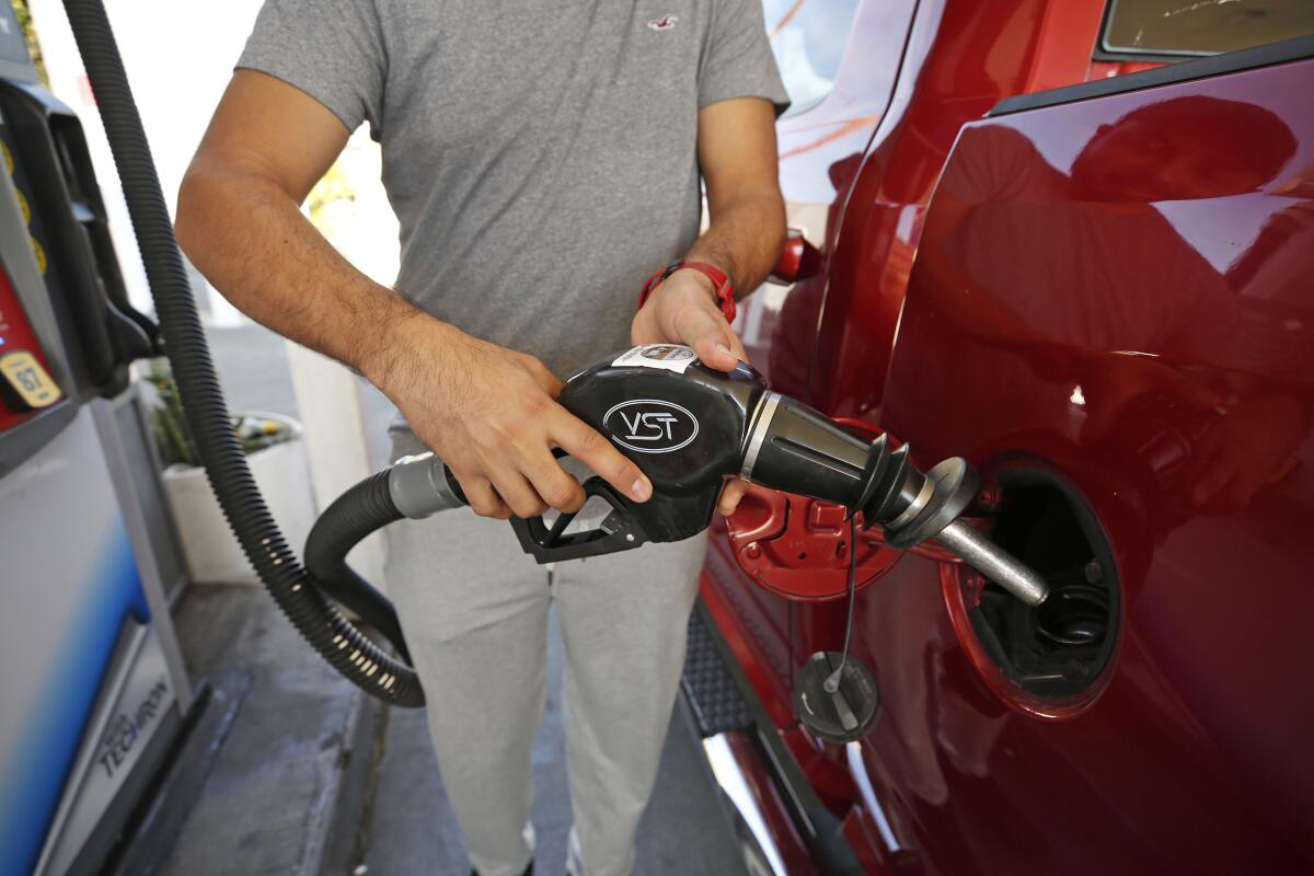 A motorist prepares to fill their gas tank with fuel