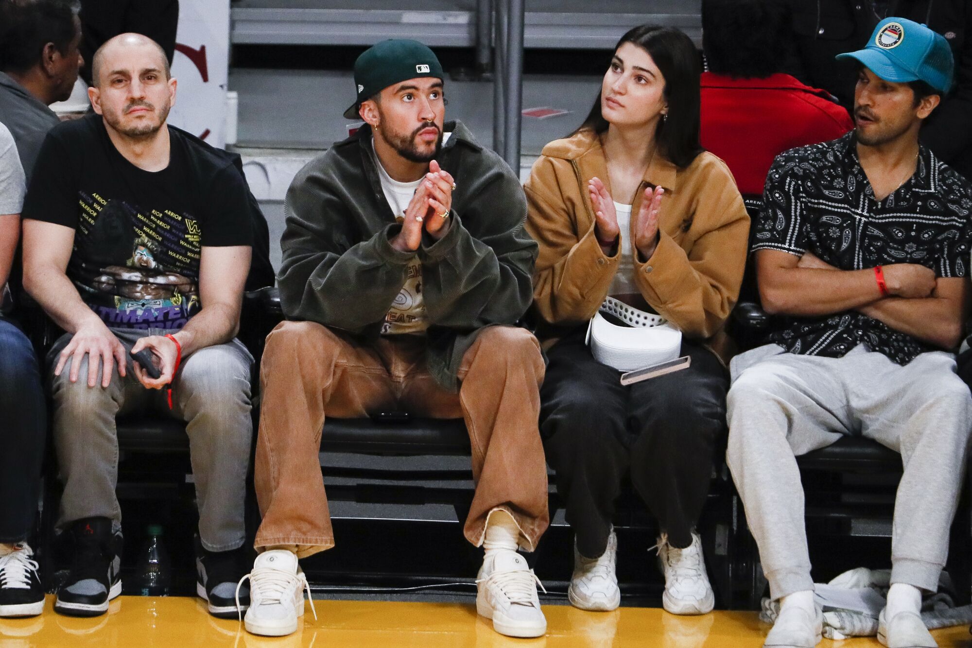 Musician Bad Bunny watches from the sidelines.