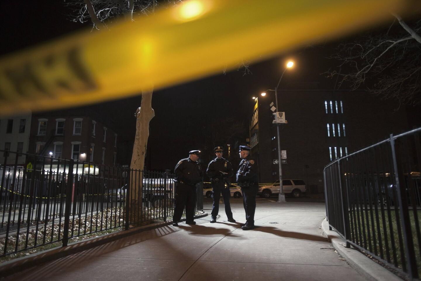 Police are pictured at the scene of a shooting where two New York Police officers were shot dead in the Brooklyn borough of New York