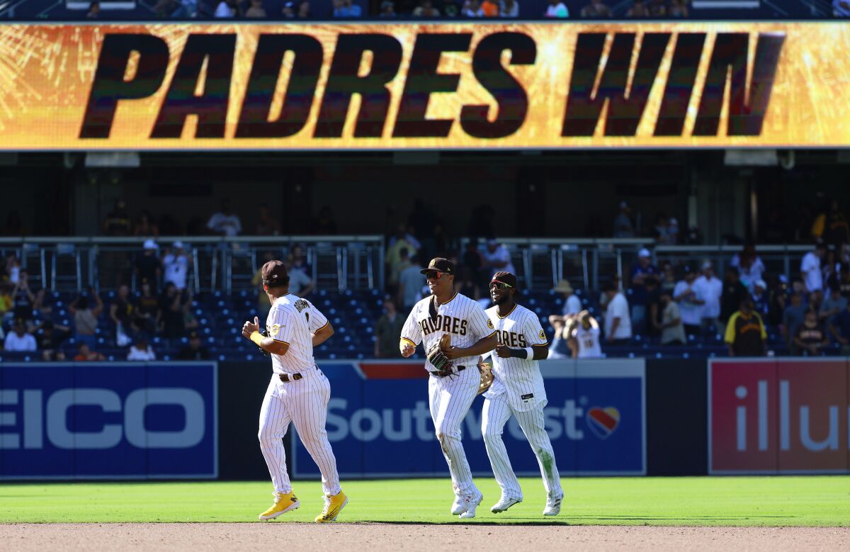 Padres outfielders Trent Grisham, Juan Soto, and Jurickson Profar run in after a victory over the Giants at Petco Park.