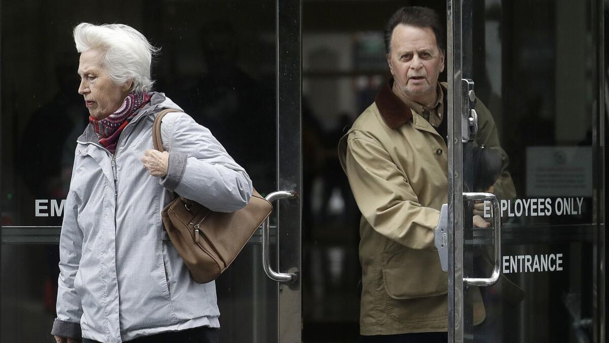 Edwin Hardeman, right, leaves a federal courthouse with his wife, Mary, in San Francisco. A jury will decide whether Roundup weed killer caused Hardeman's cancer.