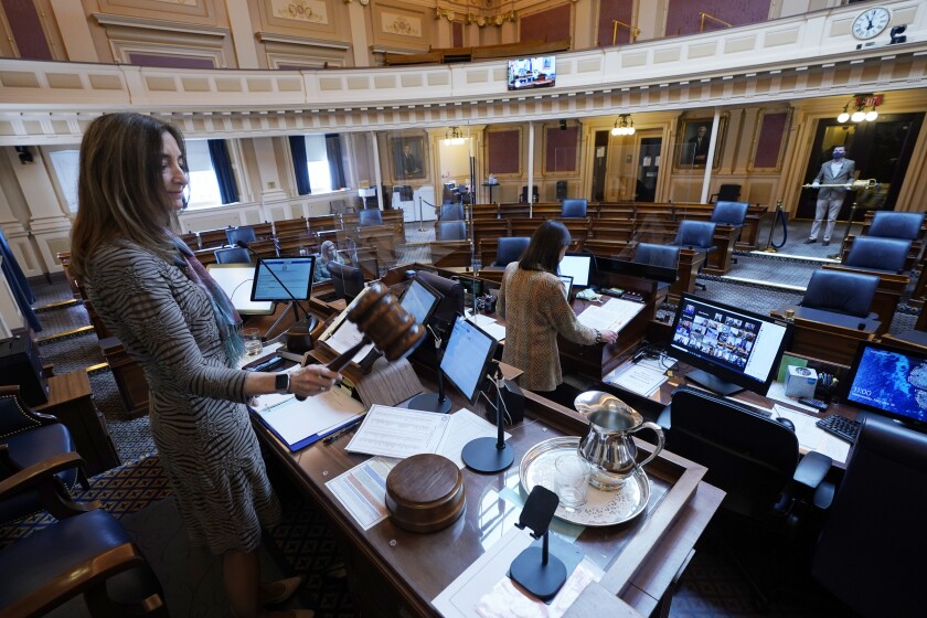 FILE - In this Feb. 10, 2021, file photo, House speaker Del. Eileen Filler-Corn, D-Fairfax, gavels in the session to an empty Virginia House of Delegates chamber after a Zoom Legislative session at the Capitol in Richmond, Va. A year after COVID-19 triggered government shutdowns and crowd limitations, more public bodies than ever are livestreaming their meetings for anyone to watch from a computer, television or smartphone. But in some cases, it's become harder for people to actually talk with their elected officials. (AP Photo/Steve Helber, File)