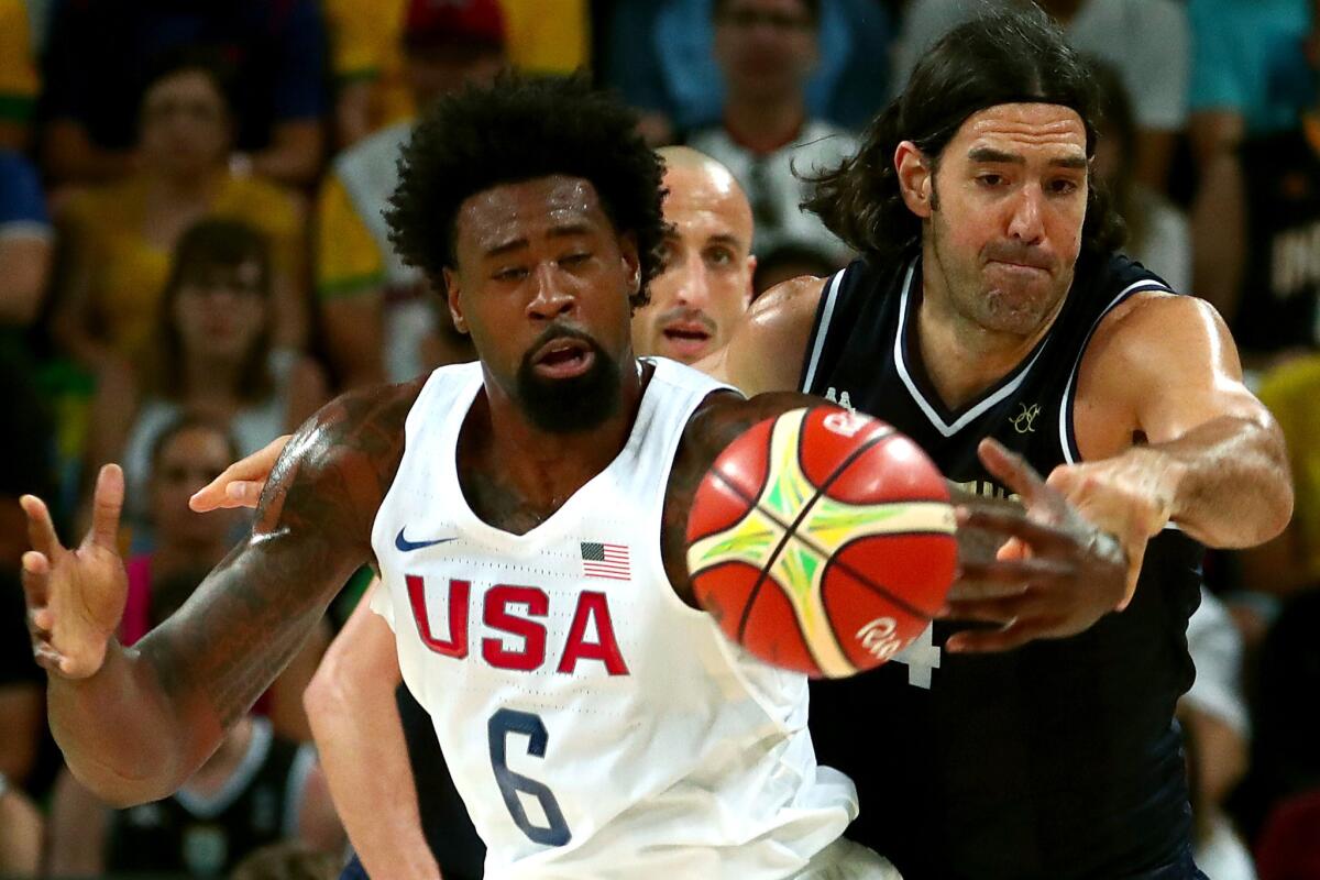 Argentina center Luis Scola knocks the ball away from U.S. center DeAndre Jordan during first quarter action