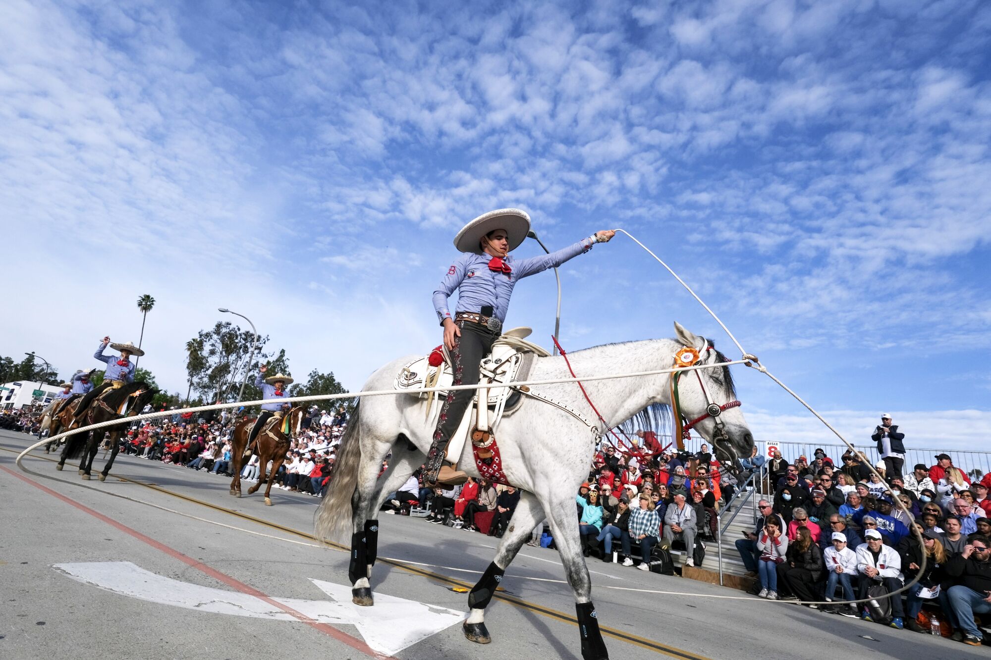 A man on a horse twirls during the Rose Parade on Monday.