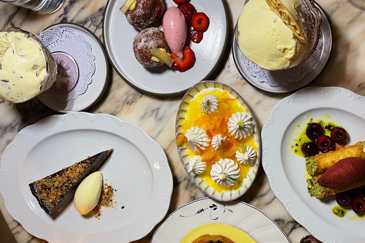 A marble tabletop full of desserts at Funke: tarts, meringues, cannoli, gelati and sorbetti.
