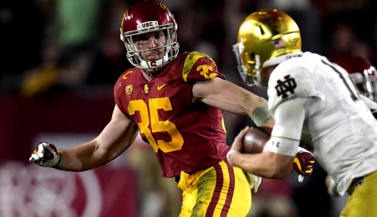 USC linebacker Cameron Smith (35) chases down Notre Dame quarterback Ian Book.