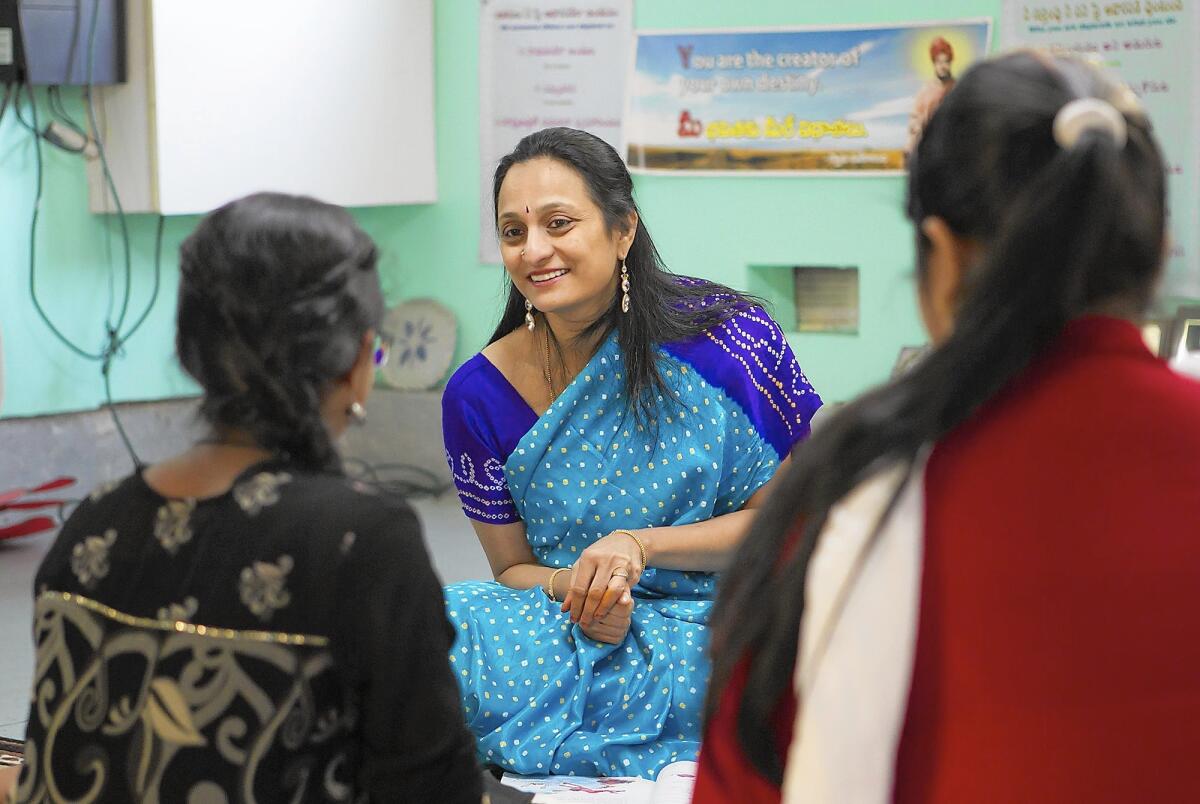 Vidya Tandanki works with students at her home-based Telugu Thota school in Irvine.